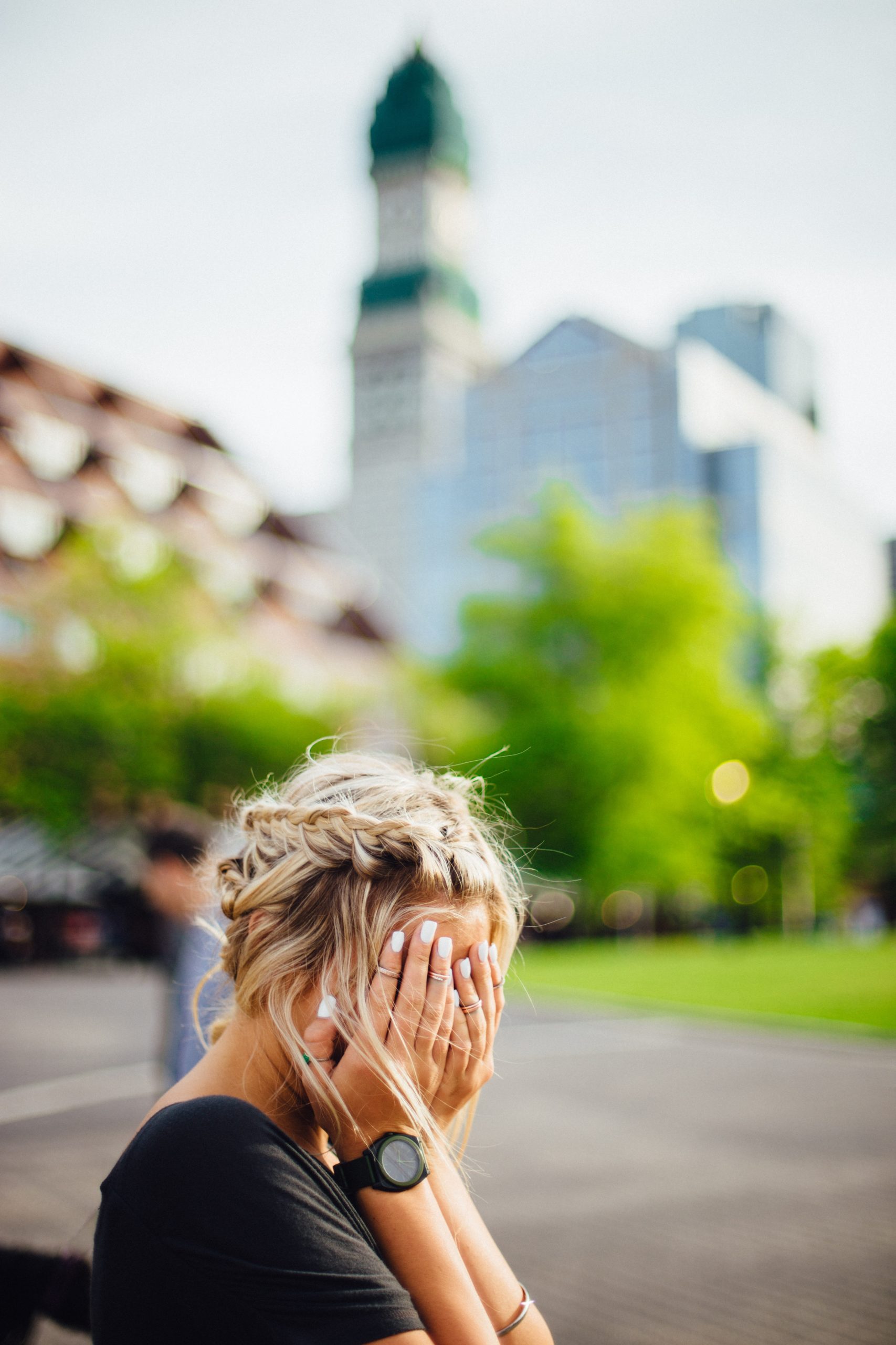 young woman sitting on a bench upset about worries and anxiety